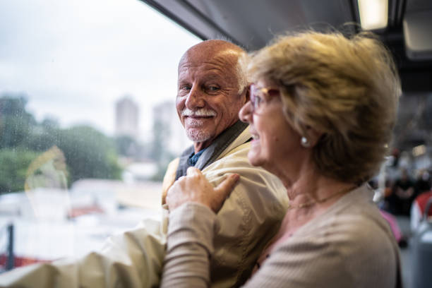 istock Contemplative senior couple looking through window in the subway train 1423124439