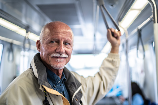 Portrait of a senior man in the subway train