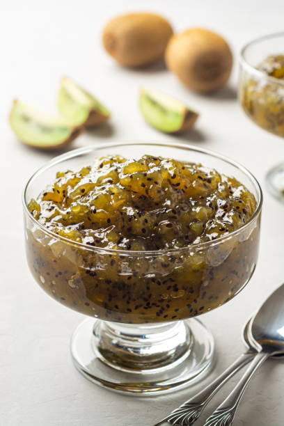 Homemade kiwi jam in dessert glass on concrete background