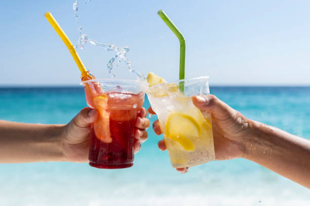 istock Splashing refreshment juices in front of a sea view 1423135401