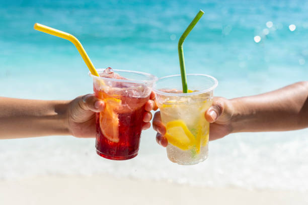 istock Splashing refreshment juices in front of a sea view 1423135404