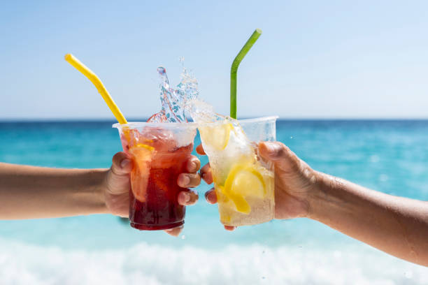 istock Splashing refreshment juices in front of a sea view 1423135428