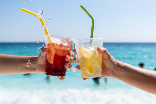 istock Splashing refreshment juices in front of a sea view 1423135551