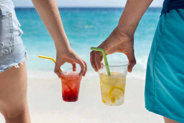 amigos están compartiendo bebidas en la playa - drinking straw drinking juice women fotografías e imágenes de stock