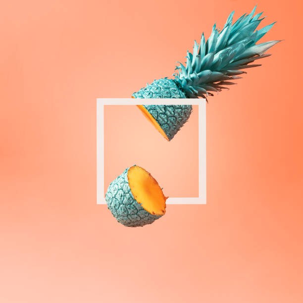 istock Creative summer layout of a frame and a cut pineapple on an orange background. 1423137321