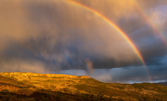 Beautiful double rainbow rain storm and sunset over the Land's End portion of the Grand Mesa near Grand Junction, CO.