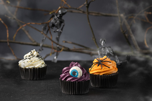 Halloween cupcakes with buttercream and holiday decoration. Halloween muffin. Halloween creative food.