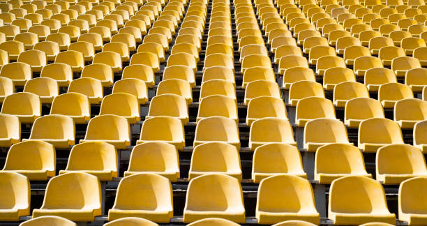 asientos de tribuna en el estadio deportivo. arena exterior vacía. concepto de ventiladores. sillas para el público. concepto de entorno cultural. color y simetría. asientos vacíos. estadio moderno. tribunas amarillas - gradas fotografías e imágenes de stock