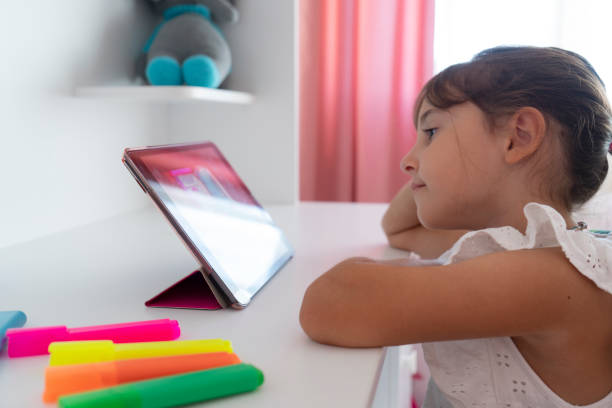 istock Cute Girl sitting at home and studying over internet 1423146637