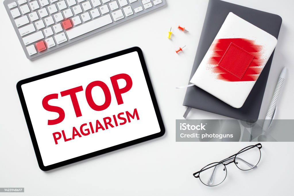 Stop plagiarism concept. Flat lay digital tablet with text STOP PLAGIARISM on screen, keyboard with lighted keys control c, paper notebooks, glasses on white desk. Imitation Stock Photo