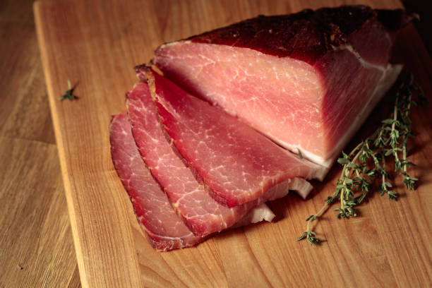 istock Dry-cured pork with thyme on a cutting board. 1423149736