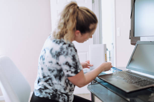 Woman Connecting Router In Home Office