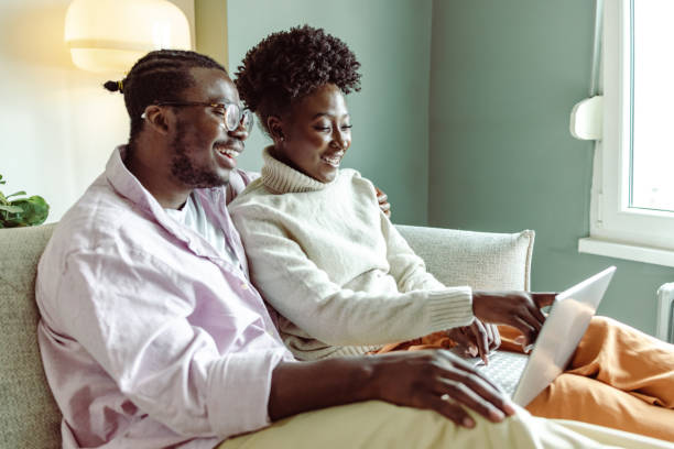 istock Young African-American consuming internet content on laptop at home 1423150663