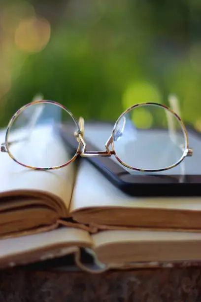 Photo of Books, E-Reader and Glasses