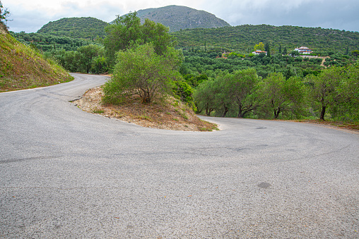 Dusty road on the Mediterranean coast over beautiful Parga city