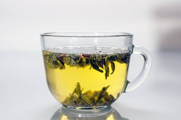 istock glass cup with green tea reflected in gray glass 1423154713