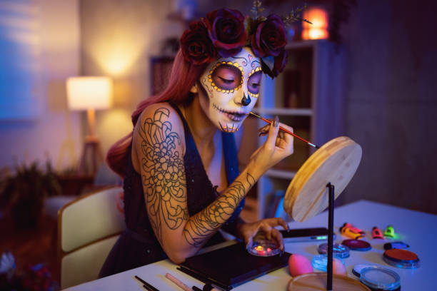 istock Young woman doing make-up for Day of the Dead celebration 1423155456