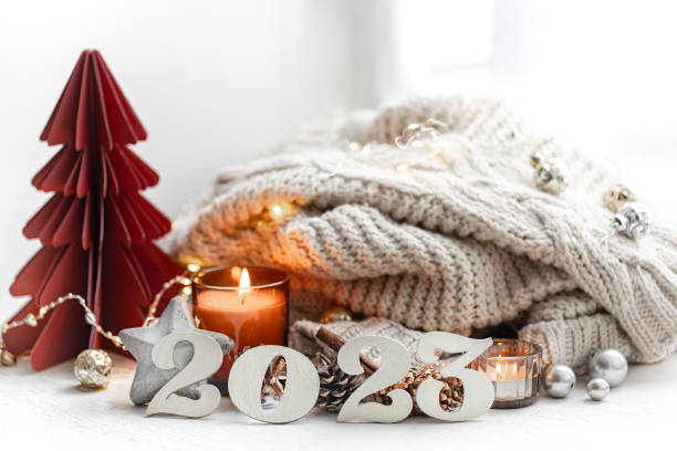 istock Christmas background with decorative numbers 2023 and cozy details. 1423160565
