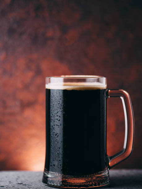 istock A mug of dark draft beer. Close-up on a brown background 1423161186