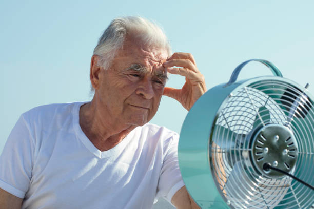 istock Elderly Man with Fan 1423162514