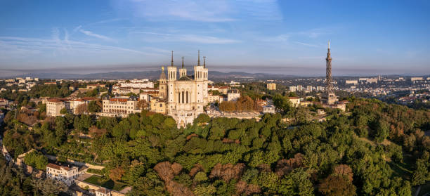 der drohnen-panoramablick auf die basilika notre-dame de fourvière und den metallturm auf der spitze des hügels. - basilika notre dame de fourvière stock-fotos und bilder