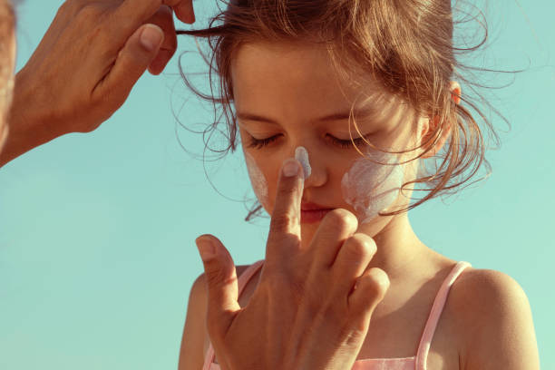 istock Mother Applying Sun Cream on Daughter's Face 1423163689