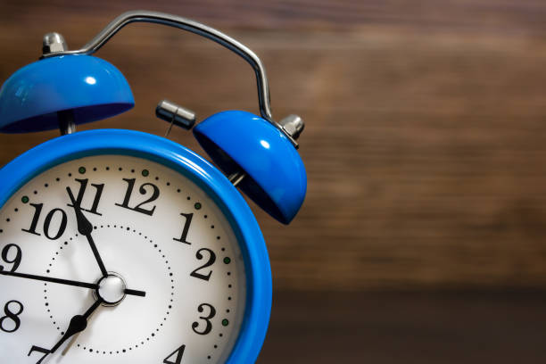 istock Blue alarm clock close-up on a wooden background 1423163711