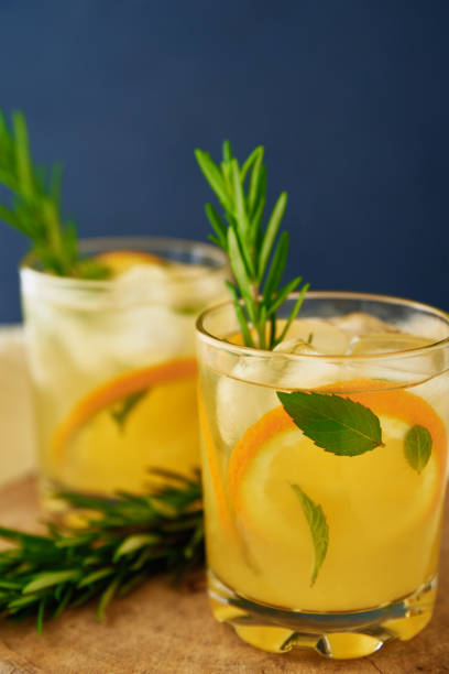 istock Glass of orange lemonade on dark background 1423163767