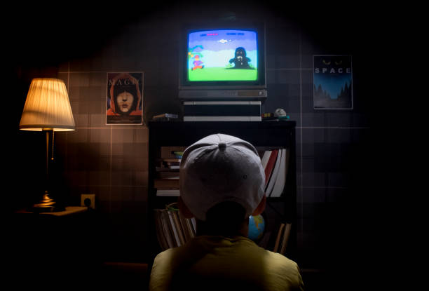 istock Kid sitting at tv screen playing console video game 1423164648