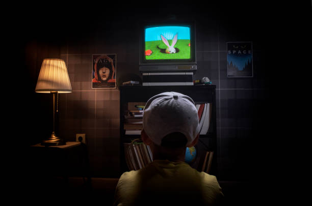 istock Little boy sitting on the floor watching tv 1423164680