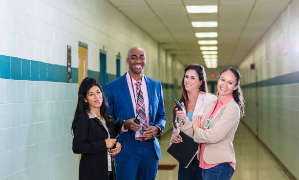 istock Multiracial teachers having meeting in school corridor 1423165469