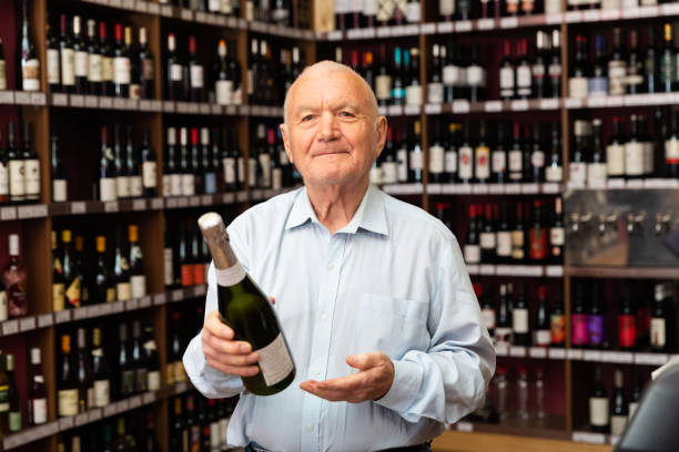 istock Attentive elderly man chooses champagne in a liquor store 1423166029