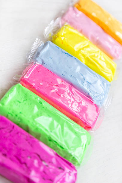 istock Multicolored clay plasticine or dough on wooden white table 1423166835