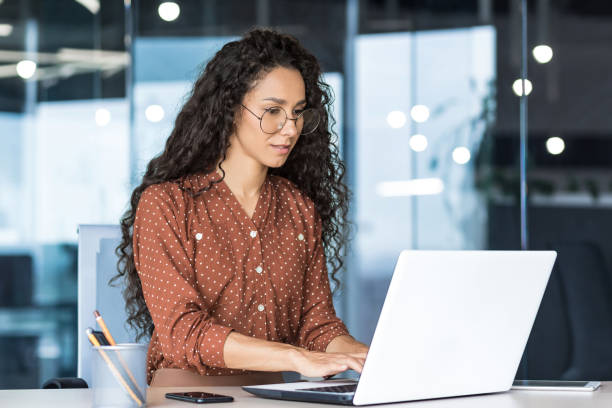 istock Beautiful indian woman programmer web developer focused and confident working on laptop writing code programming business woman worker in modern office working in casual clothes 1423167211