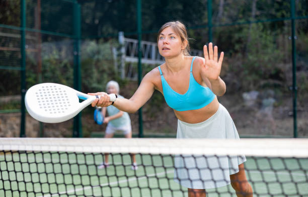 istock Training while playing on tennis court. Woman learning to play paddle 1423167702
