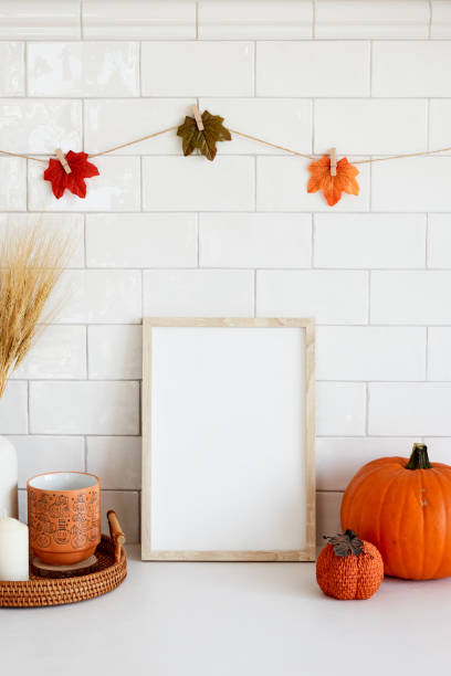 istock Living room interior design with autumn fall decor and picture frame mockup. Thanksgiving, Halloween holiday poster concept. 1423167749