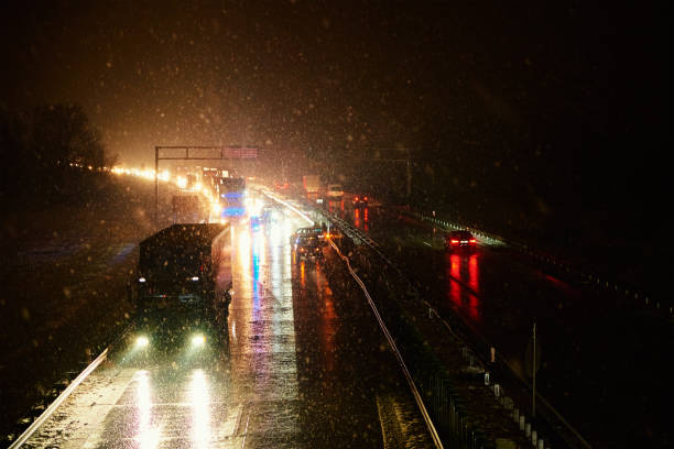 istock Car accident on slippery road at night during snowfall 1423168604