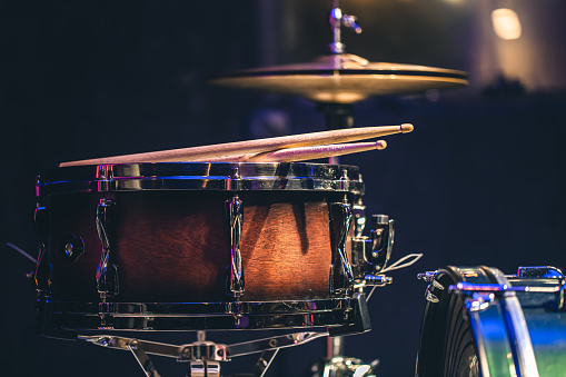 Part of a drum kit on a black background, percussion instrument, snare drum and hi-hat.