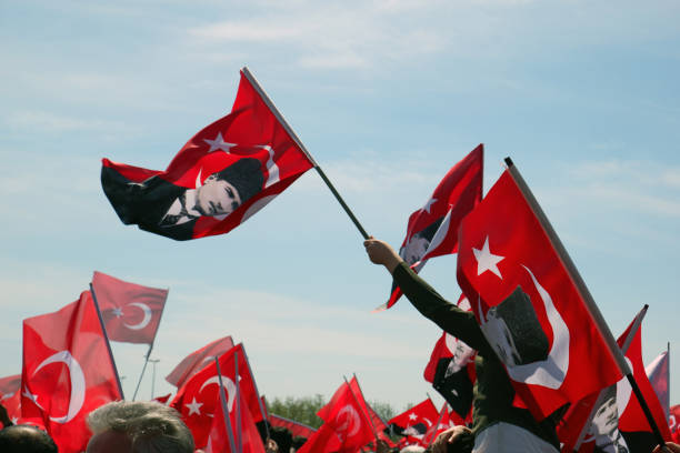 Istanbul, Türkiye, April 21,2019: Turkish flags raised in the hands of people gathered at a rally or celebration of national day.