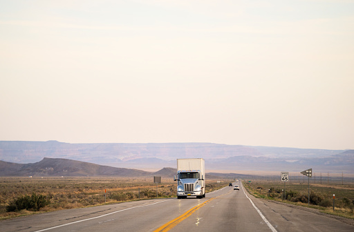 White and blue semi truck transporting merchandising in Utah, USA