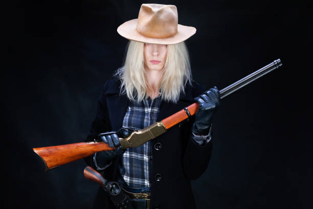 istock wild west girl with rifle 1423171710