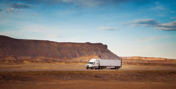 istock White semi transporting merchandising in Utah, USA 1423171795