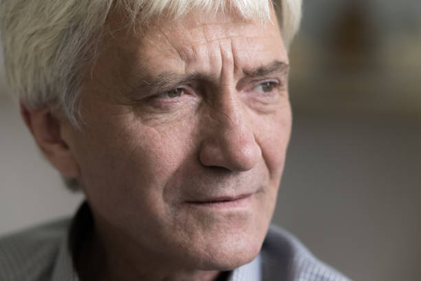 istock Thoughtful concerned senior old man face close up cropped shot 1423172461