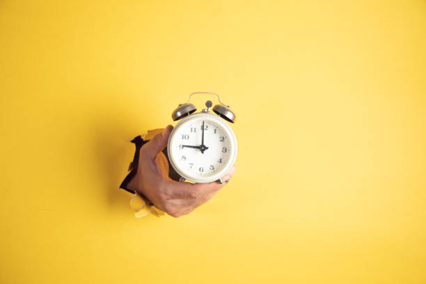 istock A man hand holds a vintage alarm clock 1423172682