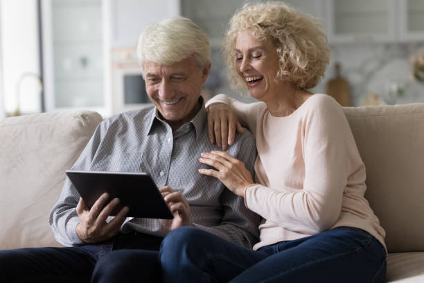 istock Cheerful couple shopping on Internet with ecommerce online app 1423172722