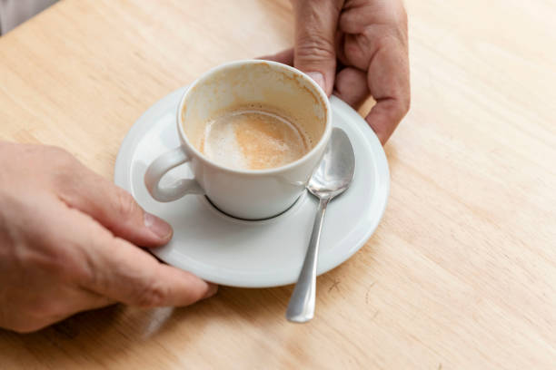 istock Hands holding a cup of coffee on the table 1423172877
