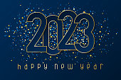 istock Happy New Year 2023 poster with numbers cut out of paper and with confetti. 1423174422