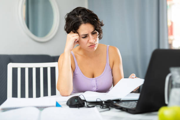 istock Tired woman working with laptop at home 1423174636