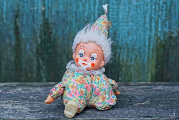 istock one small colored clown toy sits on a gray table 1423177563