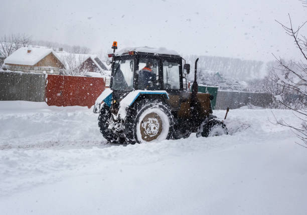 istock A small tractor clears the road from snow 1423180003